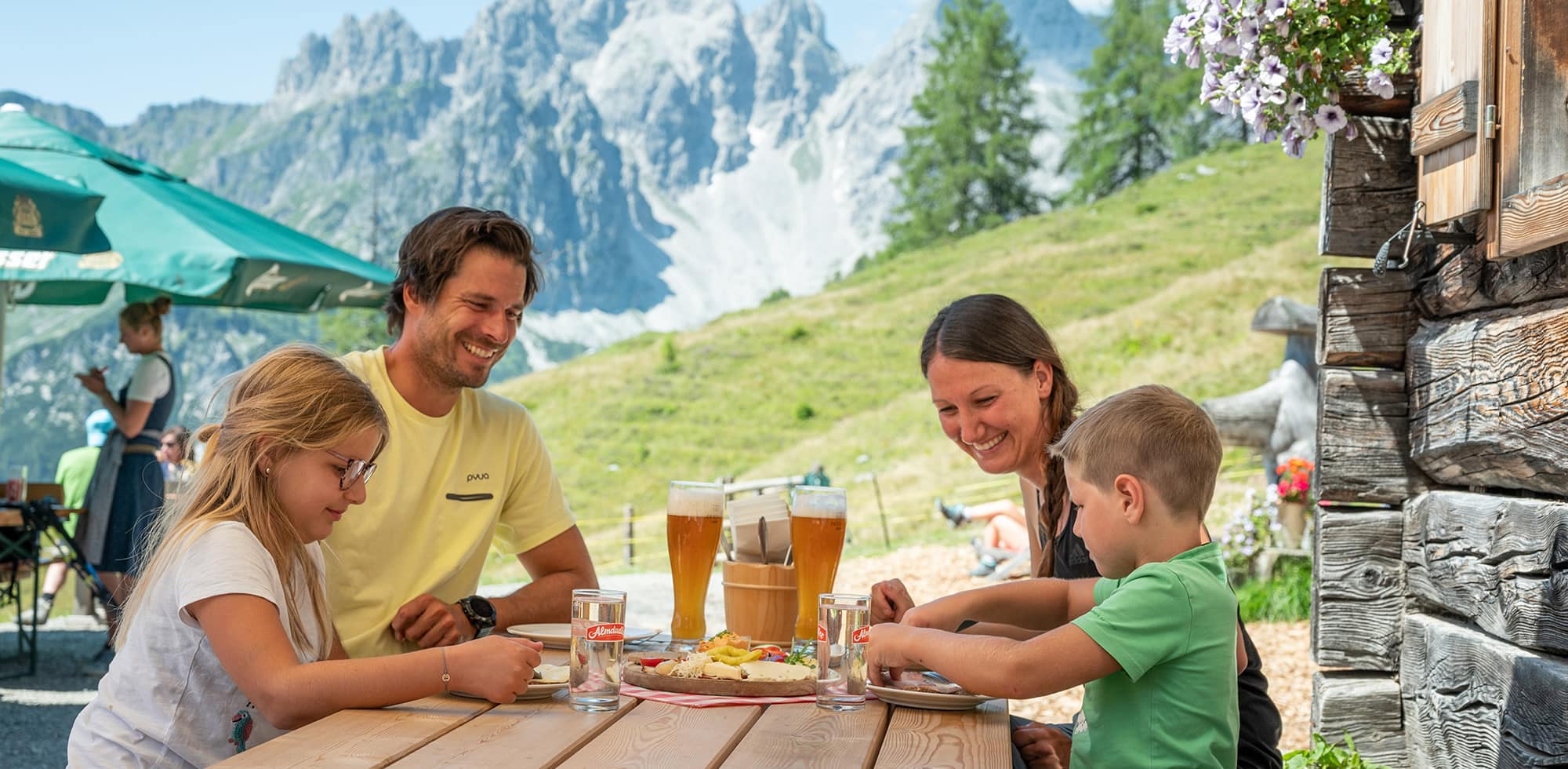 Familienurlaub im Sommer bei einer Einkehr in eine Almhütte